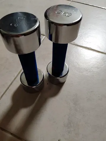 Pair of small chrome dumbbells with blue foam grips - each 2 kg weights