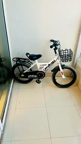 White childrens bicycle with basket and rear rack - good condition