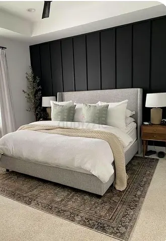 Light grey upholstered double bed with headboard