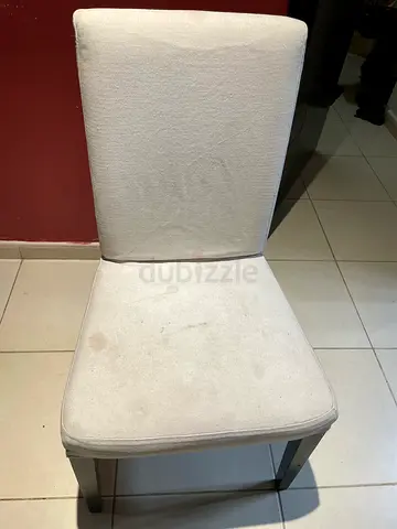 Used beige upholstered dining chair with dark wooden legs