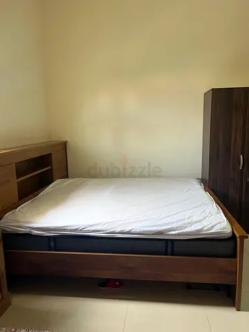 Solid wood queen bed frame with built-in headboard storage - good condition
