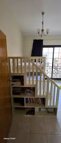White bunk bed with built-in shelves — good condition