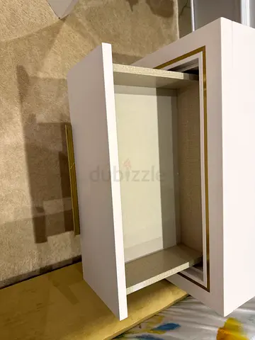 White lacquer bedside table with gold trim and  drawer