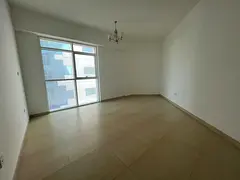 Two bedrooms and a living room with a balcony, storage room, laundry room, and parking