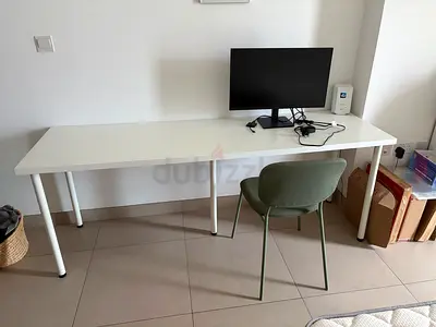 Remote work set up : long white desk, chair and Samsung screen