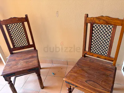 Pair of solid wood dining chairs with carved metal backs — good used condition