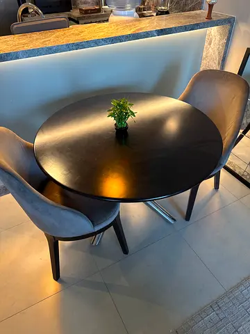 Small round dining table with two upholstered chairs - dark wood finish