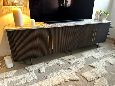 Long ribbed wood TV cabinet with marble top