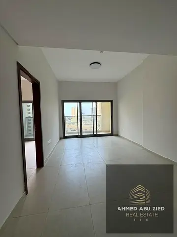 Spacious and elegant 1BR apartment for rent in Emirates City, open garden view, gym & pool in the tower, free parking, 4–6 payments, security cheque.