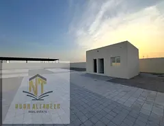 Land for Rent in Al Sajaa Fully fenced land with office and bathroom, suitable for industrial or com