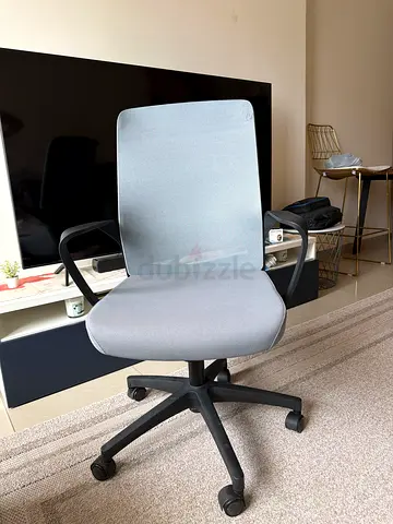 Light grey ergonomic office chair with armrests and wheels