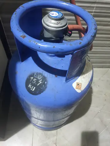 15.7 kg Blue LPG Gas Cylinder with Regulator (Used) and more than 50% gas on it.