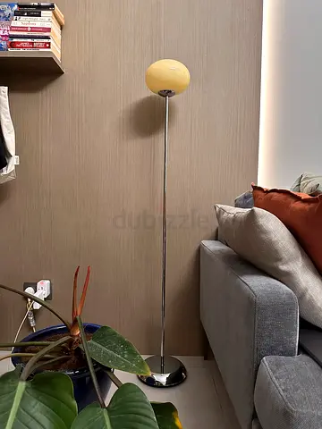 Chrome floor lamp with round yellow glass shade
