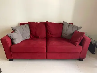 Red 3-seater Sofa in Good Condition with Cushions( Rate negotiable)