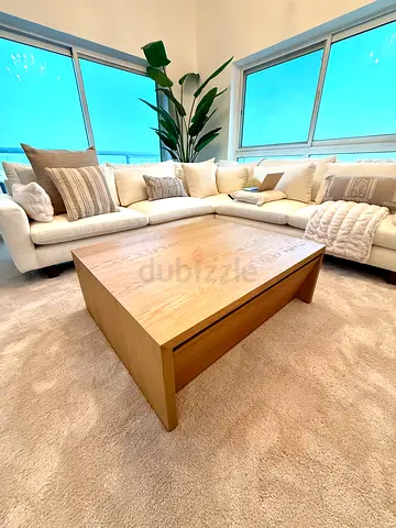 Crate  Barrel natural wood coffee table with storage.