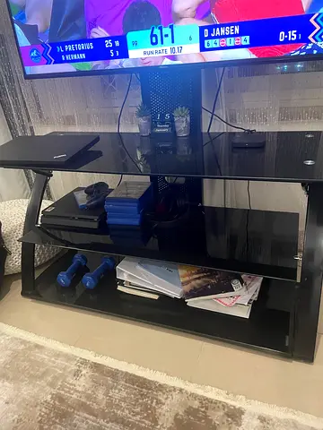 Black glass TV stand with open shelves - good used condition