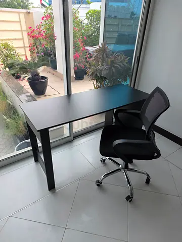 Simple black office desk with ergonomic swivel chair - good condition