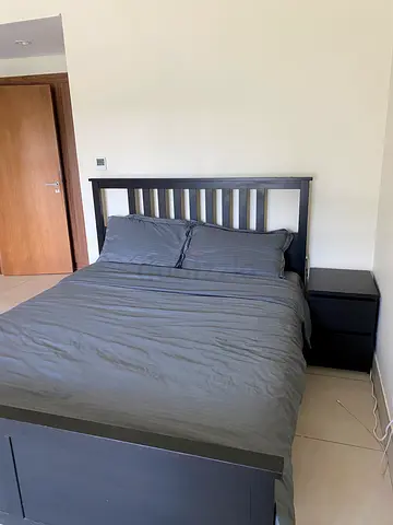 Queen bed frame with mattress and two bedside tables - dark wood