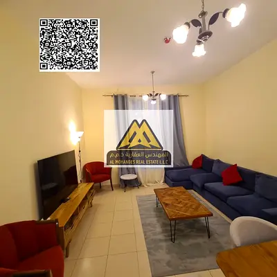 A spacious 2-bedroom apartment with a living room for annual rent in City Tower – Al Nuaimiya 3, Ajman. It features a closed kitchen, balcony, and a p