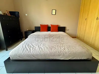 King-size Ikea bed frame in black with bedside table and very little used mattress