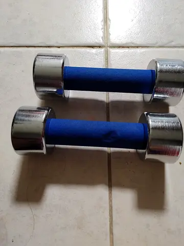Pair of small chrome dumbbells with blue foam grips - light weights