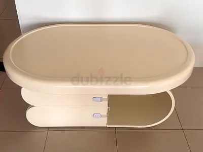 Compact Oval Coffee Table with Built-in Shelf and Sliding Door - Cream