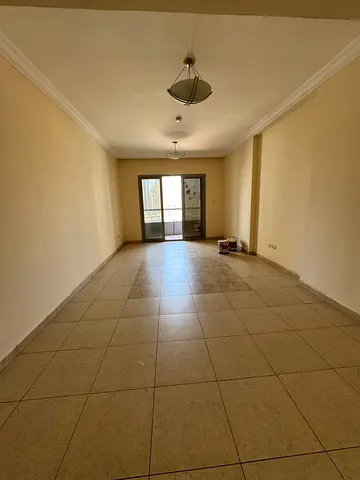 With free parking available, a large three-bedroom apartment with a living room is available for annual rent in Sharjah, including a maid's room. Prim