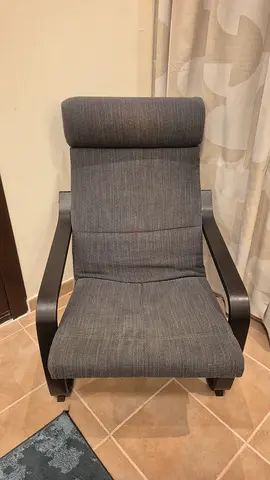 Grey IKEA-style Poäng lounge armchair.