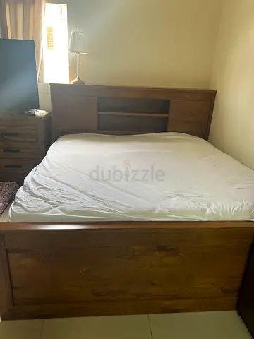 Solid wood queen bed frame with built-in headboard storage - good condition