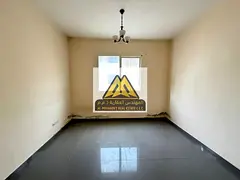 Spacious studio apartment for rent in Al Aaliyah, Ajman, with a separate kitchen and central air con