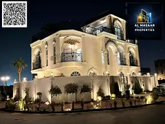 In Al Bahia area, Ajman, a corner villa with two floors and a roof, fully air-conditioned, freehold