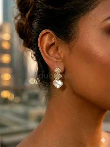 Gold-tone drop earrings with pavé crystals and mother-of-pearl drops
