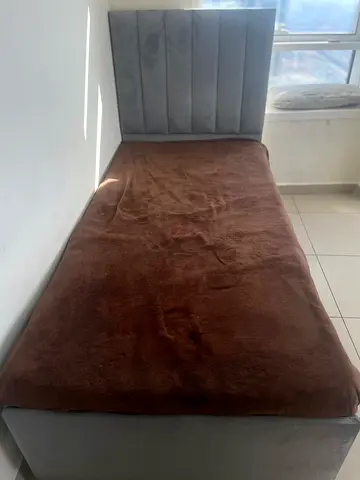 Single grey upholstered bed with padded headboard – good condition