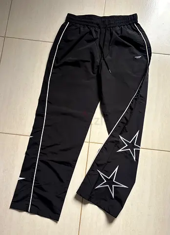 Black track pants with star print - size M