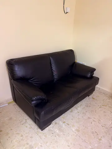 Two-seater dark brown leather sofa in good condition