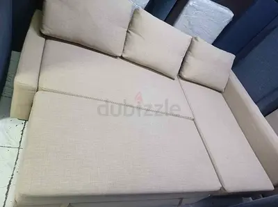 Beige Fabric L-shaped Sofa Bed with Cushions - Good Condition