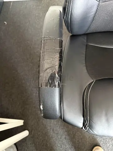 Black ergonomic gaming/office swivel chair with armrests