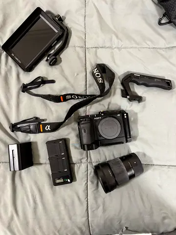 Full Sony a6600 camera setup, Sigma 30mm f1.4, monitor, cage, top handle, SD card