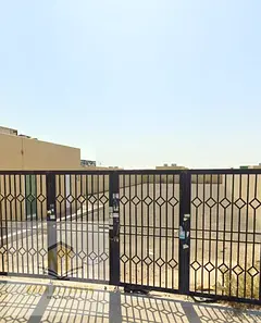 Prime ready land for sale in Al Sajaa area. A fenced industrial plot with a permit (ground + first f