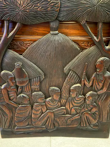 Hand-Carved Wooden Panel Depicting Traditional Village Scene