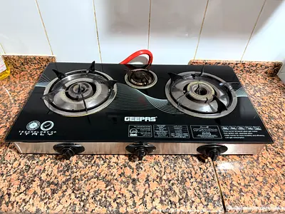 Geepas 3-Burner Glass Top Gas Stove - Good Working Condition with empty cylinder, regulator and pipe