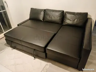 Black faux leather L-shaped sofa bed - converts to bed, good condition