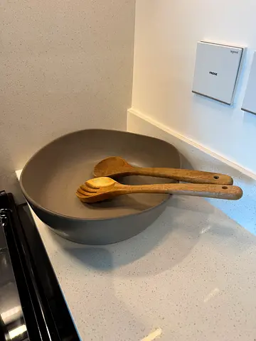 Serving bowl with wooden salad servers