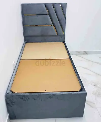 Single grey upholstered bed frame with headboard