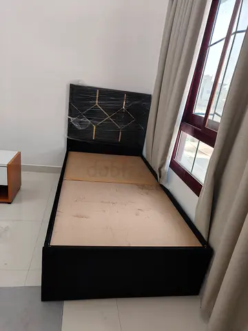 Single black bed frame with mattress