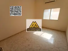 A spacious studio for annual rent in Al Rawda 3 – Ajman, featuring a separate kitchen and split AC