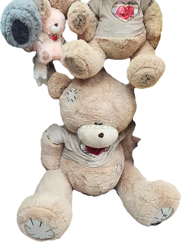 Large beige plush teddy bear with smaller stuffed toys - used