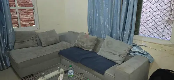 Light grey L-shaped fabric corner sofa — good condition, reversible cushions - Ajman, Al Rawda 1,