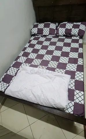 Double size Solid wood bed with mattress and one single mattress  in good condition for sale.