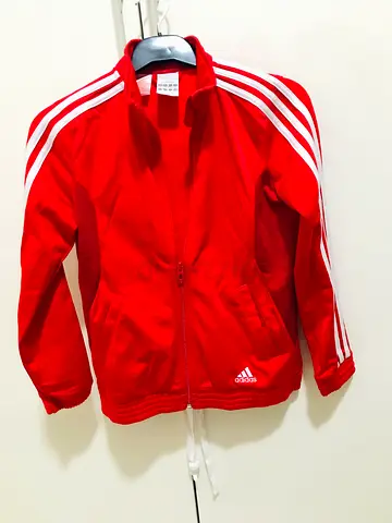 Adidas red jacket for kids aged 9-10 for 65 aed.